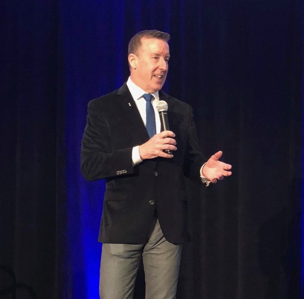 Doug Dane speaking on stage